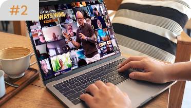 Close-up of hands typing on a laptop displaying a Zoom-style virtual meeting titled "The Presenter Always Wins Bootcamp" featuring Eric Worre.