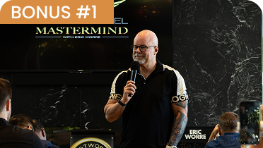 Eric Worre holding a microphone and smiling while standing in front of a dark, textured wall with his name displayed in the corner.